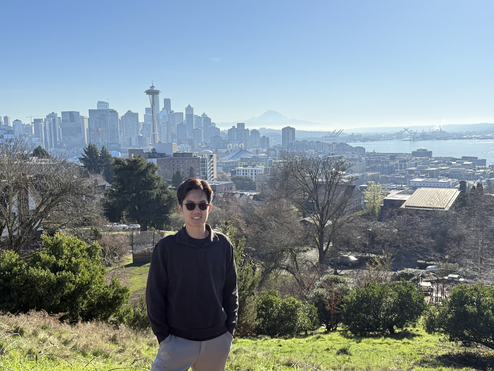 Michael at Kerry Park, Seattle, with the skyline and Mount Rainier behind, photo by Ting Gong